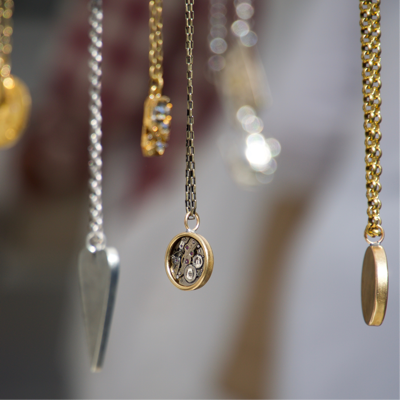 Gold and silver necklaces hanging on display.